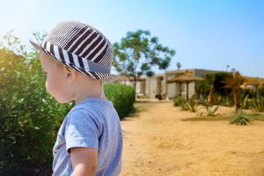 Gücenmiş küçük çocuk arkasını döndü ve üzgündü. Tatil köyündeki genç çocuğun portresi. Duygusal çocuk.