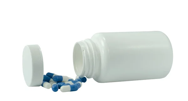 Some white and blue pills with white jar — Stock Photo, Image