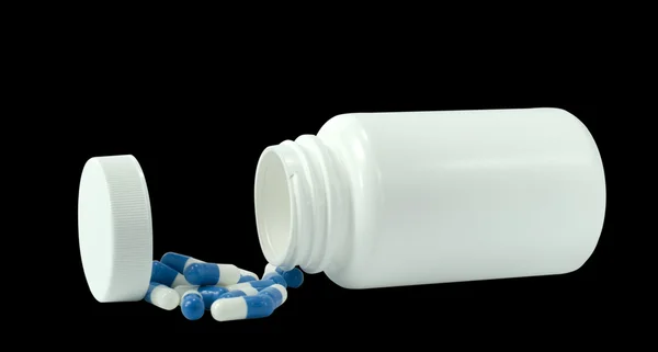 Some pills of a white and blue colors with white jar — Stock Photo, Image