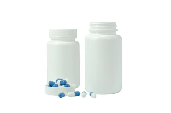 Some pills of a white and blue colors with two white jar — Stock Photo, Image