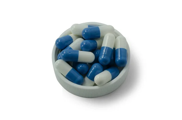 Деякі таблетки білого і синього кольорів з білою шапочкою — стокове фото