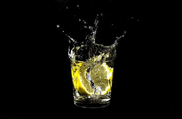 Lemon splashing in glass — Stock Photo, Image