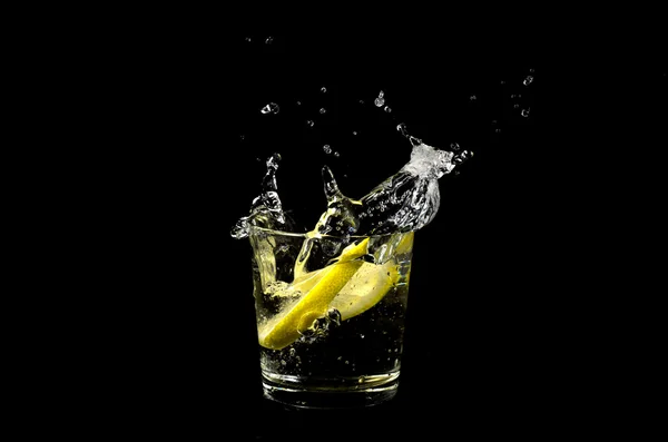 Lemon splashing in glass Stock Photo