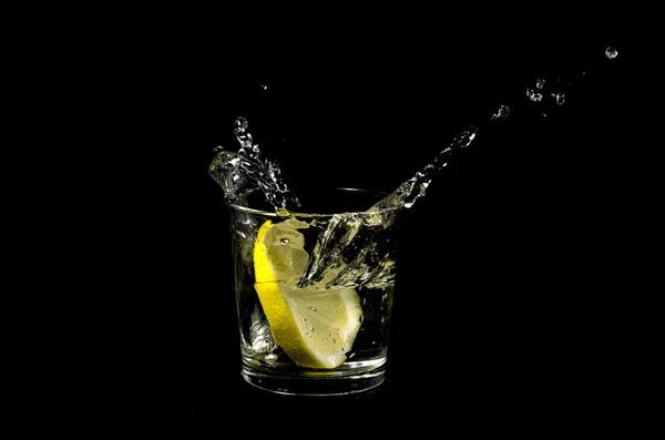 Lemon splashing in glass Royalty Free Stock Photos