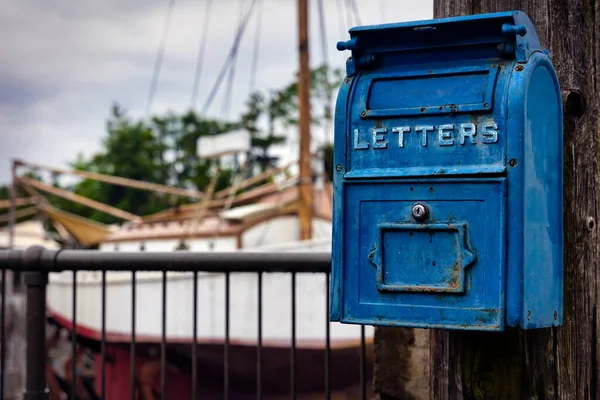 An old fashioned US Post Office mail box hangs on a telephone in Osaka, Japan.