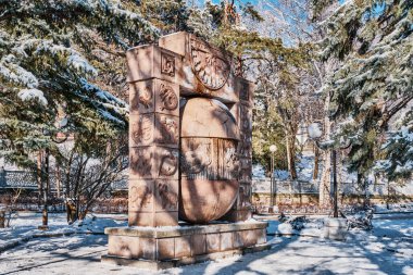 Zheleznovodsk, Russia - January 21, 2021: The resort park in the winter. Stone sculpture sundial Zodiac signs, the egg of desires.
