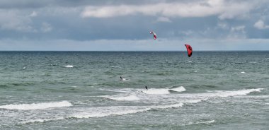 Dalgalara binen iki uçurtmacı ile güzel bir deniz manzarası..