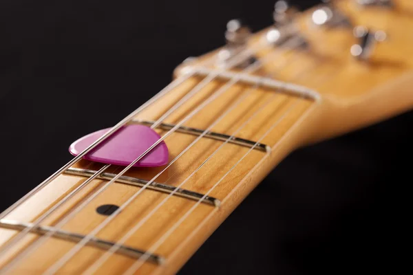 Close-up of a guitar neck with pink pick — Stock Photo, Image