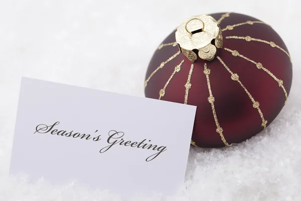 Christmas Ornaments with card and words 'season's greeting'