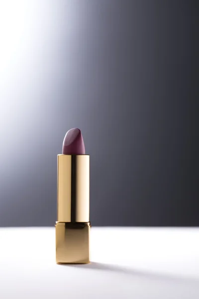 Lipstick on grey background — Stock Photo, Image