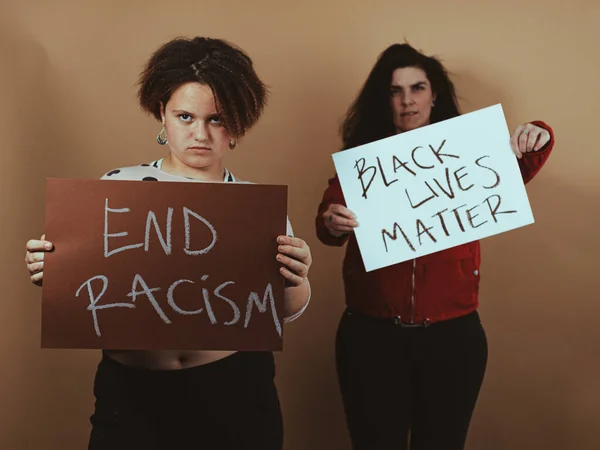 two women with anti-racism posters