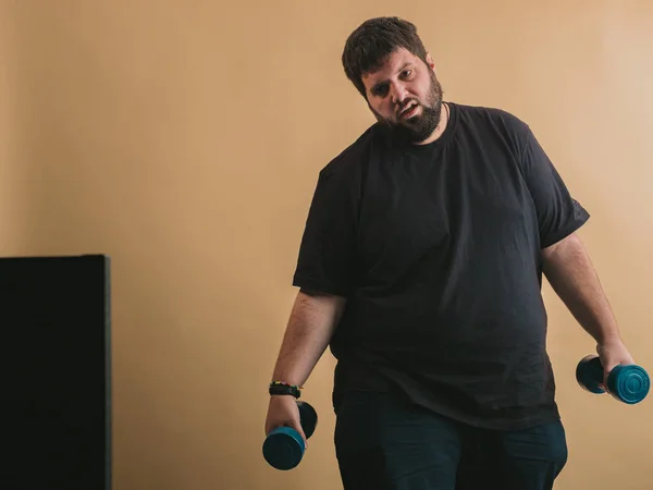 Obese man doing sports in an online class on computer