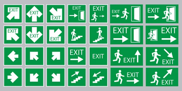 Багато знаків виходу з білими стрілками на зеленому тлі. Концепція евакуації. Векторні ілюстрації. Зберігати зображення . — стоковий вектор