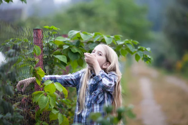 Happy Blond Girl Eating Berries Bush Cute Girl Wearing Plaid — Zdjęcie stockowe