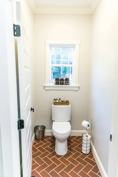 Large white renovated master bathroom toilet area with red brick floors — Stock Photo, Image