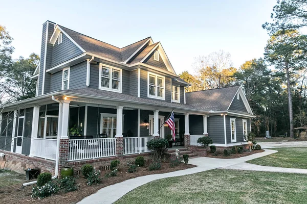 Front view of a large two story blue gray house with wood and vinyl siding — Stock Photo, Image