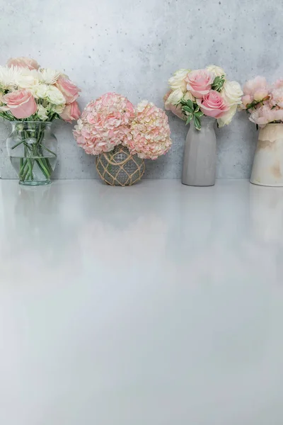 Varios ramos de flores de rosa, peonía y hortensias contra una pared vertical de hormigón —  Fotos de Stock