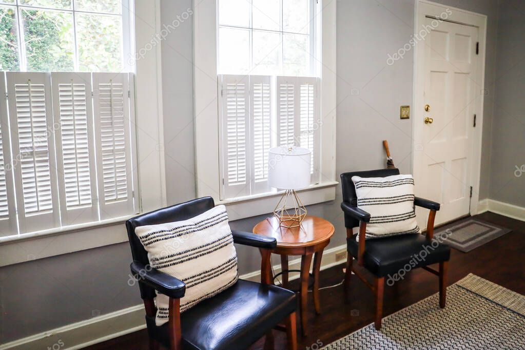 two guest chairs in living room of a small cottage short term rental