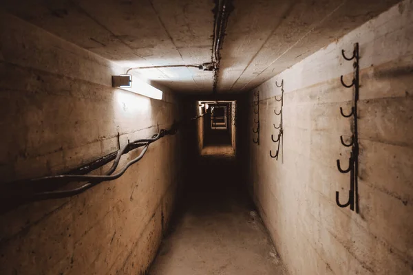 Dark corridor of old abandoned Soviet underground bunker. Defocused