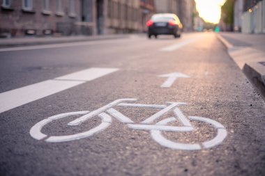 Separate bicycle lane for riding bicycles. A white bicycle symbol on the road. Selective focus