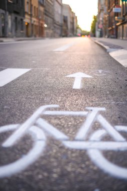 Separate bicycle lane for riding bicycles. A white bicycle symbol on the road. Selective focus