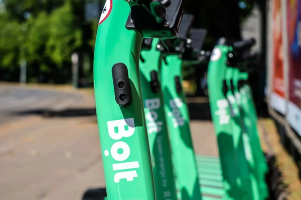 Riga, Latvia - July 18, 2022: Bolt electric rental scooters are parked on a sidewalk in Riga. Defocused — Stock Photo, Image