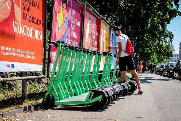 Riga, Latvia - July 18, 2022: Bolt electric rental scooters are parked on a sidewalk in Riga. Defocused — Stock Photo, Image