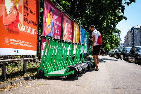 Riga, Latvia - July 18, 2022: Bolt electric rental scooters are parked on a sidewalk in Riga. Defocused — Stock Photo, Image