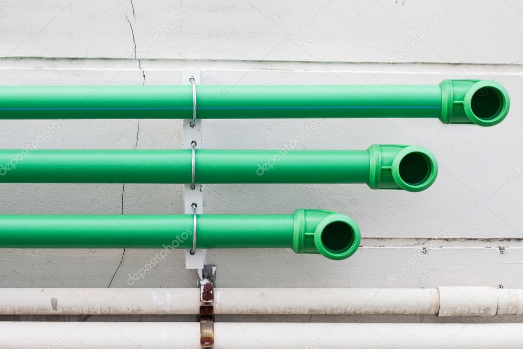 green pipes on cement wall