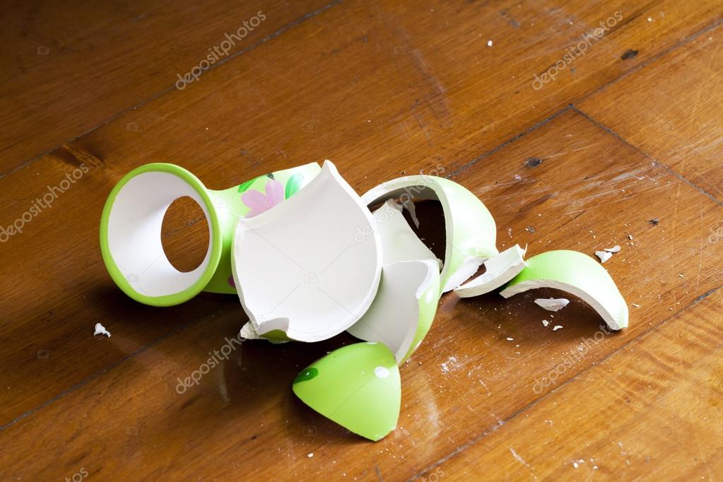 Broken vase on wooden floor — Stock Photo © enterphoto 99502920