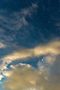 Port Stephens, NSW, Avustralya 'daki Tilligerry Deresi' nde bulutlar ve yıldızlarla dolu fırtınalı bir gece..