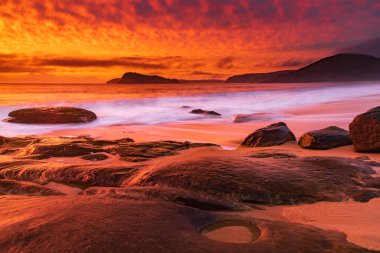 Central Coast, NSW, Avustralya 'daki Kuzey Pearl Sahili' nden yükselen bulutlu renkli gündoğumu deniz manzarası..