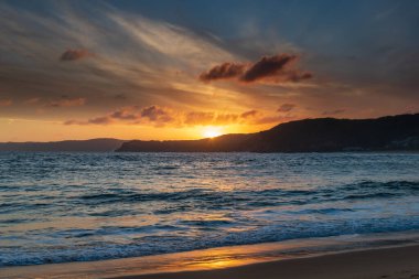 Central Coast, NSW, Avustralya 'daki Bouddi Ulusal Parkı' ndaki Putty Plajı 'nda deniz kenarında gün batımı.