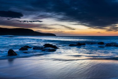 Central Coast, NSW, Avustralya 'daki Killcare Sahili' nden bulutlarla gün doğumu denizi..