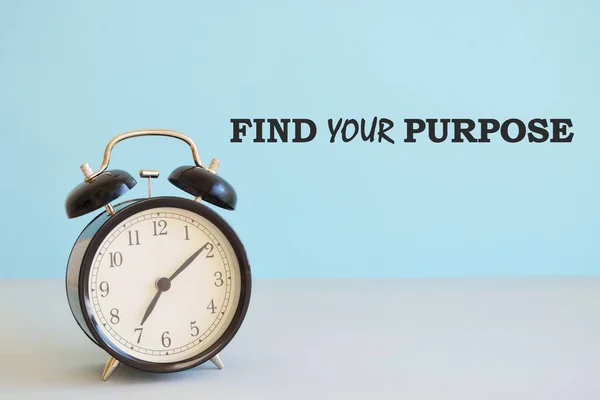 find your purpose ,motivational reminder.Business photo showcasing reason for something is done or for which still exists Alarm clock beside a Paper sheet placed on blue backdrop