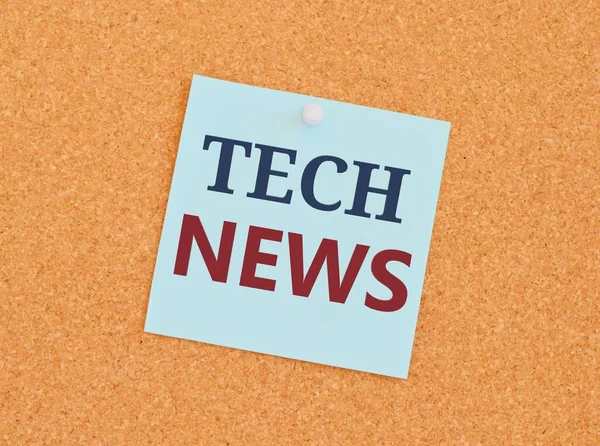 TECH NEWS written on sticky note paper over a kork board. Business concept for newly received or noteworthy information about technology.