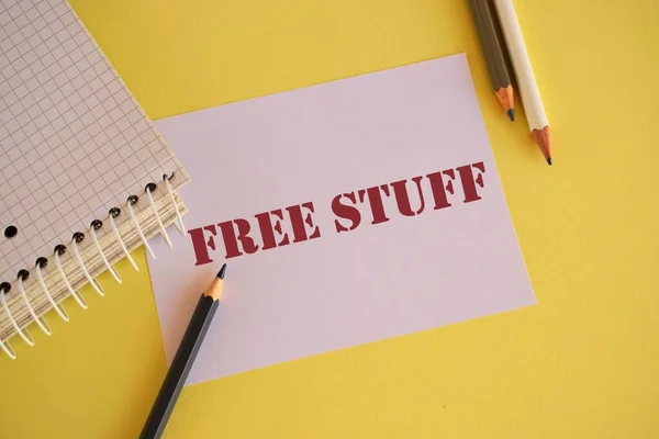FREE STUFF text written on paper. Concept meaning something that is given to you without you having to pay for it.