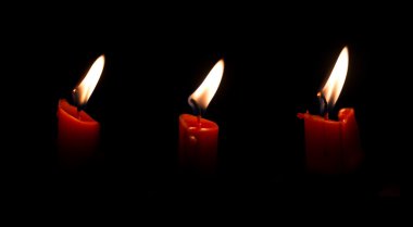 Three candle light isolated on black clipart
