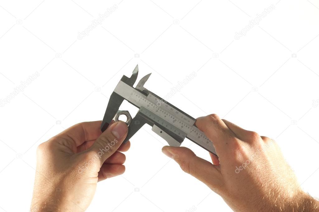 Technician hand measuring nut with caliper isolated on white