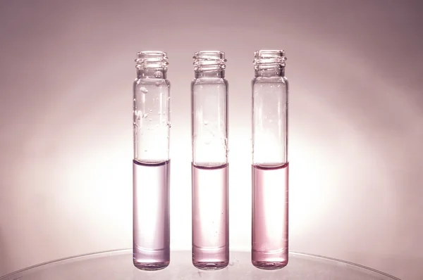 Glass vials in a row — Stock Photo, Image