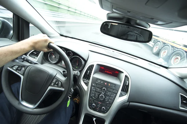 Inside view of driver at wheel on highway — Stock Photo, Image