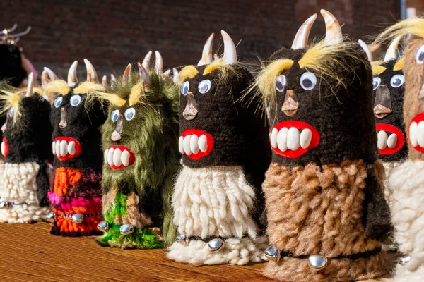 Traditional Bulgarian souvenirs - handmade kukers at fair during carnival of farewell to winter. Kukers - pagan ritual figures for frightening evil spirits. Bulgarian folklore and holidays