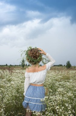 Resimli bir vadide vahşi beyaz papatyalar arasında tanınmayan bir kadın. Merhaba yaz. Dijital detoks, doğada hafta sonu, ilham aramak, anın tadını çıkarmak. Toprağın enerjisi