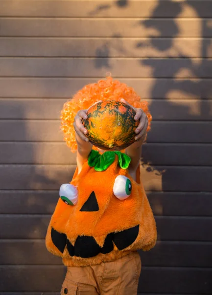Unrecognizable Child Orange Pumpkin Costume Grin Holds Pumpkin Front His — Stock Photo, Image