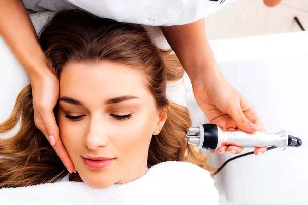 Radyoaktif yüz gerdirme ameliyatı olan kadın. Donanım yüz kozmetolojisi. RF fotoğrafı kaldırıyor.