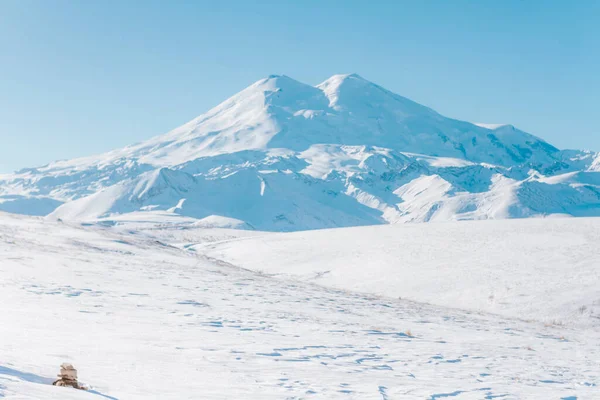 Snowy mountains of Elbrus in winter. Vacation in the mountains.
