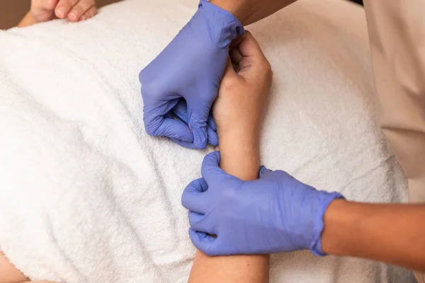 physiotherapist giving treatment with dry needling to patient