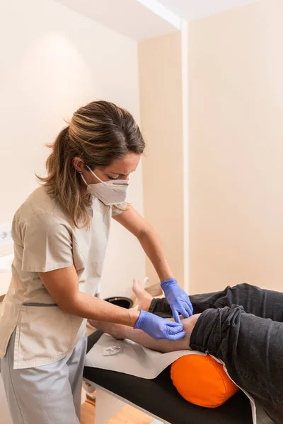 physiotherapist giving treatment with dry needling to patient