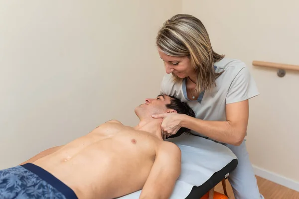 Fisioterapeuta hace sesión al hombre. manipulación cervical, estiramiento del trapecio —  Fotos de Stock