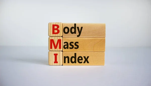 Cubes and blocks form the expression \'BMI - Body Mass Index\'. Beautiful white background, copy space. Concept.